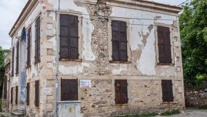 A vintage, rustic stone building with distressed facade in Foça, İzmir, Turkey.